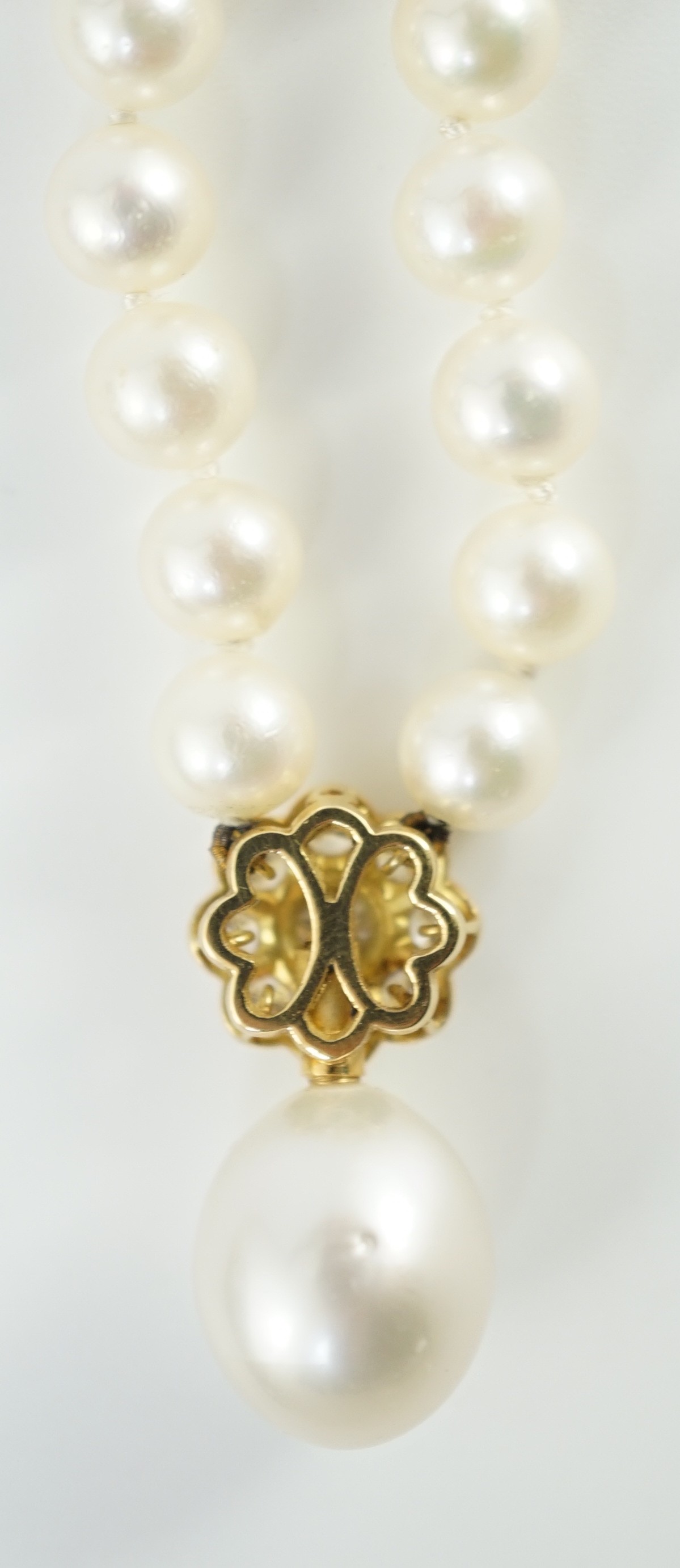 A late 1990's single strand cultured pearl and diamond cluster set necklace